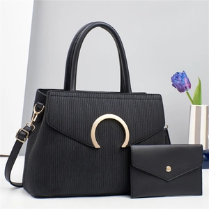 Black two-piece bag set with striped texture, gold buckle, and matching envelope wallet