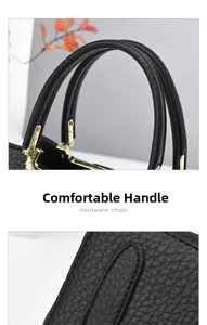 Macro shot of comfortable black lychee textured leather handles with gold hardware detail