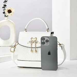 White faux crocodile tote bag with golden swan heart clasp and pearl pendant details