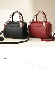 Close-up of litchi grain tote bags with silk scarf handles in black and wine red colors