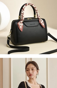 Detail of black lychee grain tote bag with fashion embossing and silk scarf handle