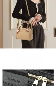 Detail of lychee pattern beige leather tote with silk scarf and gold-tone hardware