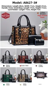 Detail view of leopard print faux leather bag set with gold rivets and metal logo
