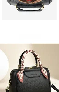 Detail view of black lychee grain tote bag with silk scarf handle and golden zipper