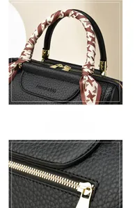 Detail of lychee pattern leather texture with decorative silk scarf and gold hardware