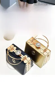 Detail of luxury mini evening bag with clover handle and diamond-encrusted clasp