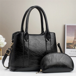 Elegant black lychee grain tote bag set with matching pouch and gold hardware accents