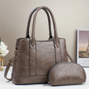 Brown tote bag and matching coin purse with adjustable strap on a minimalist background