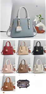 Detailansicht der gestreiften Handtasche mit Innenfächern und kleinem Münztaschenanhänger