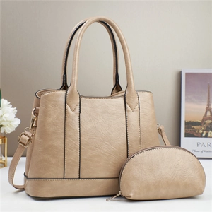 Detail of beige 2-piece tote bag set with pebble texture and golden hardware