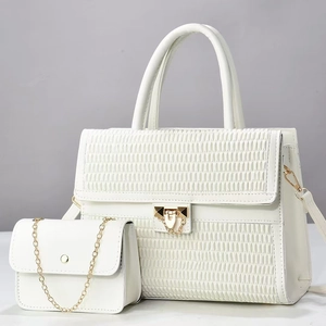 Detail of white quilted tote bag set with golden metal chain and matte PU leather texture