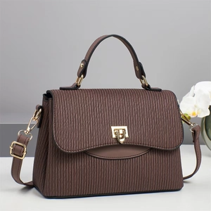 Elegant dark brown striped pleated handbag with luxury gold buckle in professional display