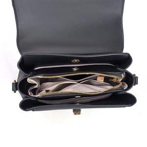 Internal view of crossbody bag featuring multi-compartment design and gold metal zipper