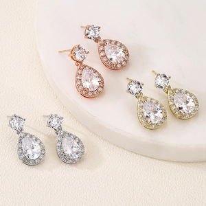 Detailed view of pear-shaped zircon earrings in rose gold, gold and silver finishes