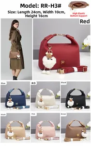 Detail view of woven texture crossbody bag with plush charm and 7 color options
