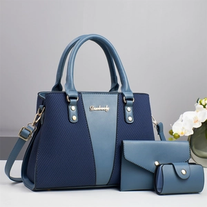 Three-piece set featuring a large blue crocodile pattern tote bag with matching clutches