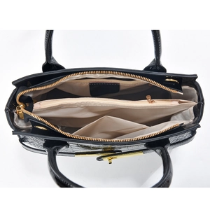 Detailed interior view of black stone texture bag with gold zippers and triple compartments