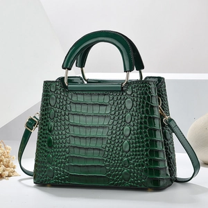 Dark green crocodile pattern handbag with metal ring handles and detachable shoulder strap
