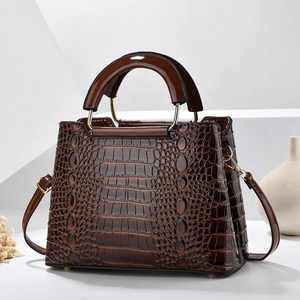 Dark brown faux crocodile leather handbag with golden hardware and top handle design