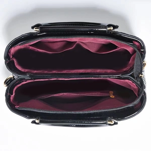 Top view of crocodile-patterned handbag showing interior compartments and wine red lining