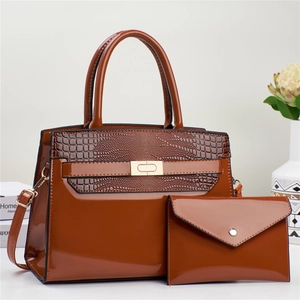 Deep brown patent leather tote bag set with crocodile texture and gold lock hardware