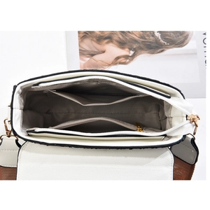 White litchi pattern leather crossbody bag featuring internal storage compartments and woven strap