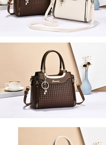 Close-up of woven leather texture and gold hardware on large crossbody handbag