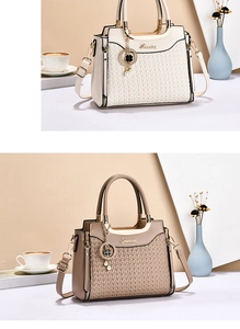 Detail of elegant woven leather texture and gold hardware on large shoulder bag