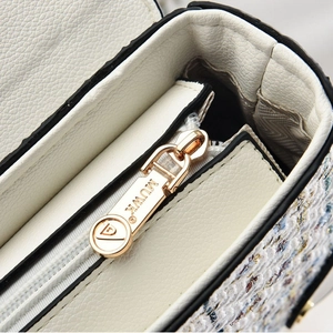 White pebbled leather crossbody bag with rabbit detail, gold zipper, and tweed panels