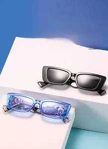 Detail of trendy rimless rectangle sunglasses in black and light blue on modern display