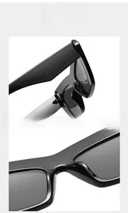 Detailed view of modern black cat-eye sunglasses featuring an integrated nose bridge