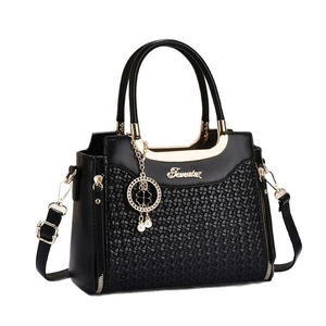 Structured black woven pattern tote bag with gold metal handles and pearl charm