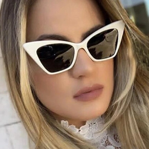 Fashionable white cat eye sunglasses with dark lenses for women worn by a model