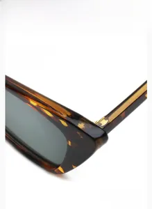 Detailed view of the tortoiseshell cat-eye sunglasses with durable metal hinges