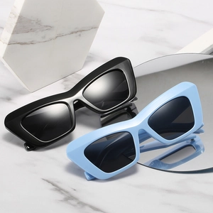 Chic cat eye sunglasses in black and light blue on a marble background with mirrors
