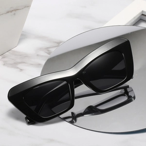 Modern black cat eye sunglasses with thick glossy frames and dark polarized lenses