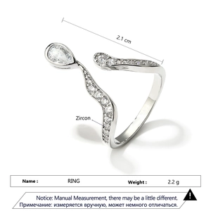 Macro detail of silver snake ring with pear-cut zircon and paved crystals in 2.1cm width