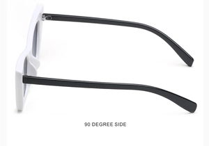 Detail view of small cat eye sunglasses with white frames and black temples from 90 degree side