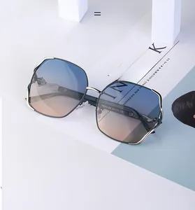 Exquisite polarized sunglasses with gold metal frame and blue-to-orange gradient lenses