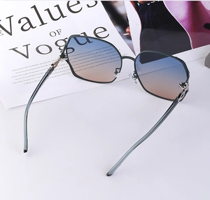 Close-up of polarized gradient lenses with elegant diamond-encrusted fox detail