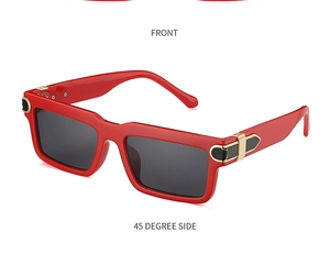 Close-up of red rectangular sunglasses featuring golden metal C-shape hinge detail