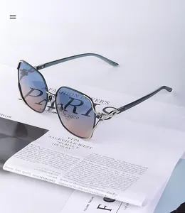 Detail of polarized oversized sunglasses with fox-shaped diamond-set temple decoration