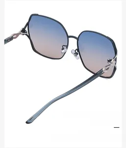 Detail of oversized sunglasses showing soft silicone nose pads and crystal-set metal temples