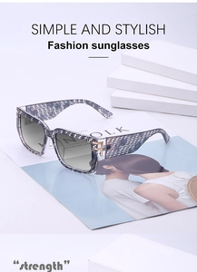 Detail of square oversized sunglasses with F-letter pattern and golden metal hinge logo