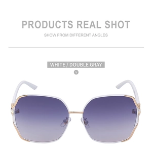 Close-up of white frame sunglasses with fox head crystal decor and gradient lenses