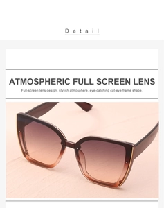 Detail view of stylish oversized cat-eye sunglasses with brown gradient full screen lenses