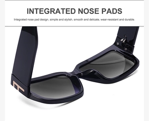 Detail of integrated nose pads and golden T-shaped metal accents on black sunglasses