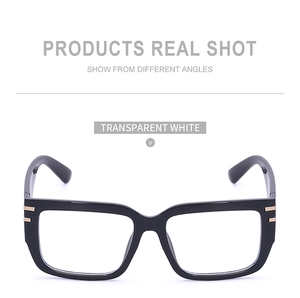 Detail showing glossy black square sunglasses frame with stylish gold metal bar accents