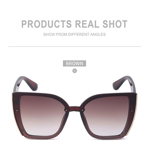 Detail shot of brown cat-eye sunglasses with gradient lenses and gold metal accents