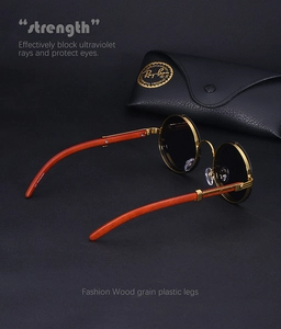 Detail of round metal sunglasses featuring wood grain texture plastic legs and UV protection